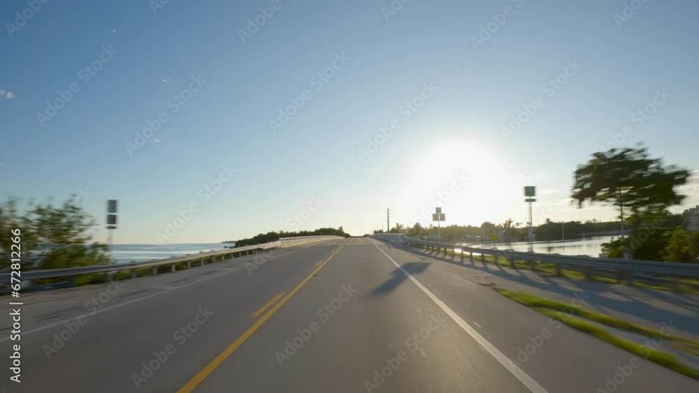 POV Driving a car towards sunset on Florida Keys Overseas Highway connecting tropical islands POV Driving a car towards sunset on Florida Keys Overseas Highway connecting tropical islands