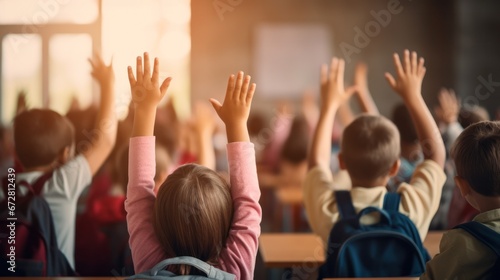 Students raise their hands to answer in the classroom. education and school concept © ETAJOE