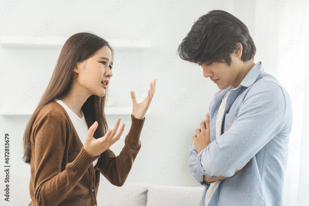 Asian young couple fight standing on white background, relationship in trouble. Different angry, use emotion shouting at each other. Argue husband has expression of disappointment and upset with wife. Asian young couple fight standing on white background, relationship in trouble. Different angry, use emotion shouting at each other. Argue husband has expression of disappointment and upset with wife.