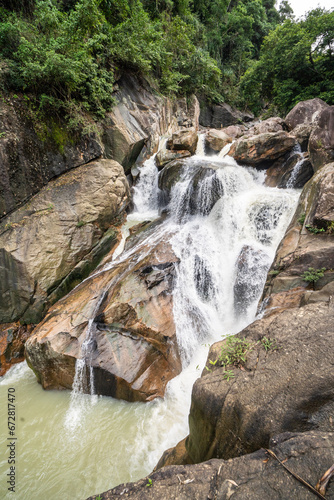 Jungle waterfall with rapid waters and large rocks in Vietnam. photo