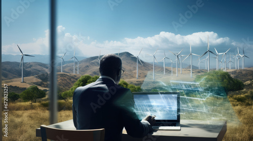 A focused businessman analyzes renewable energy designs on his laptop with holographic blueprints, in an office overlooking wind turbines.