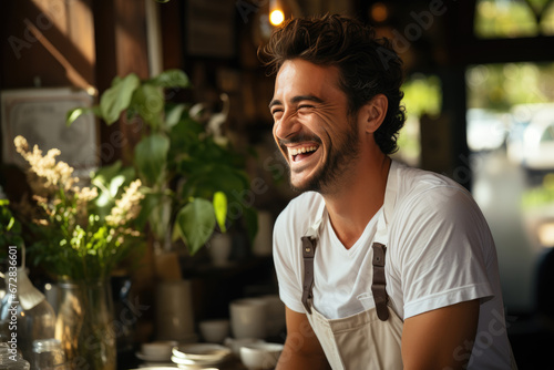 A stylish man with a contagious smile, donning glasses and fashionable clothing, enjoys a hearty laugh in a bustling outdoor cafe as he savors his meal on a quaint tableware