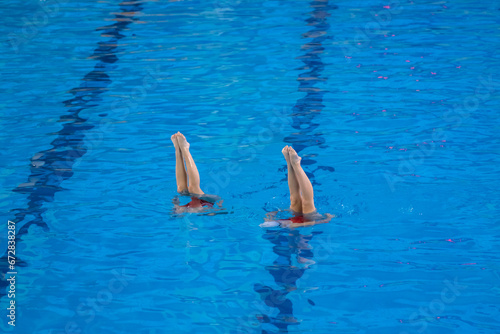 Картината върху платно artistic performance in swimming pool, group of women doing synchrone moves in t