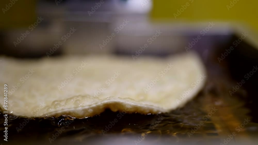 fast food in street restaurant, frying chebureki in deep fryer, unhealthy nutrition, closeup fast food in street restaurant, frying chebureki in deep fryer, unhealthy nutrition, closeup