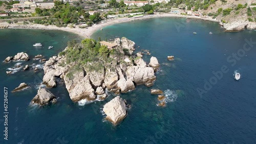 Drone flight circling over Isola Bella in Taormina, Sicily  photo