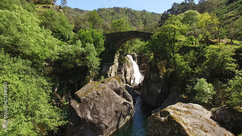 Aerial Shot of Stunning Nature Landscape in Portugal. Waterfall in the Mountains. Misarela Bridge  photo