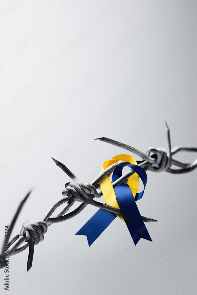 barbed wire with blue and yellow bows