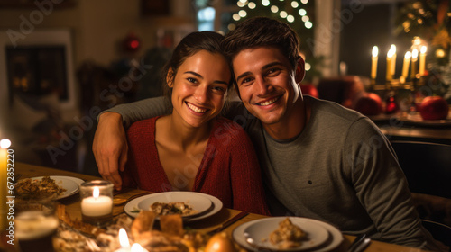 Smiling couple close together at a festive Christmas dinner setting  with lit candles and a decorated tree in the background  creating a warm and intimate atmosphere.
