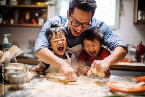 A view of a asian father with two children engaged in a fun cooking or baking activity, illustrating the joy of culinary bonding, selective focus, shallow depth of field, blurred