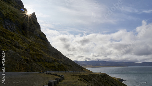 sun appearing behind coastline on snaefellsnes peninsula, iceland