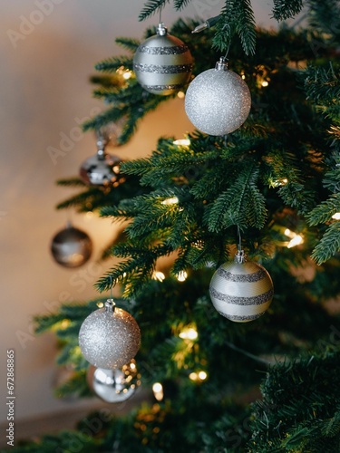 Vertical closeup of a Christmas tree decorated with sparkling balls photo