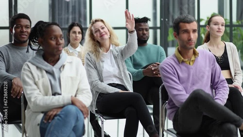 Woman raised up hands and arms in seminar class room to agree with speaker at conference seminar meeting room