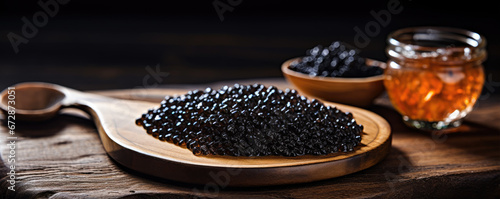 Black caviar on wooden table or board. luxury caviar meal concept