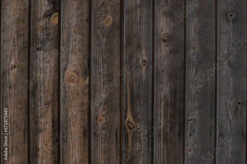 Close up photo shot rustic aged brown wood texture gradient front view. Wooden planks for natural background with vertical lines. Log cabin material - interior exterior design in traditional houses.