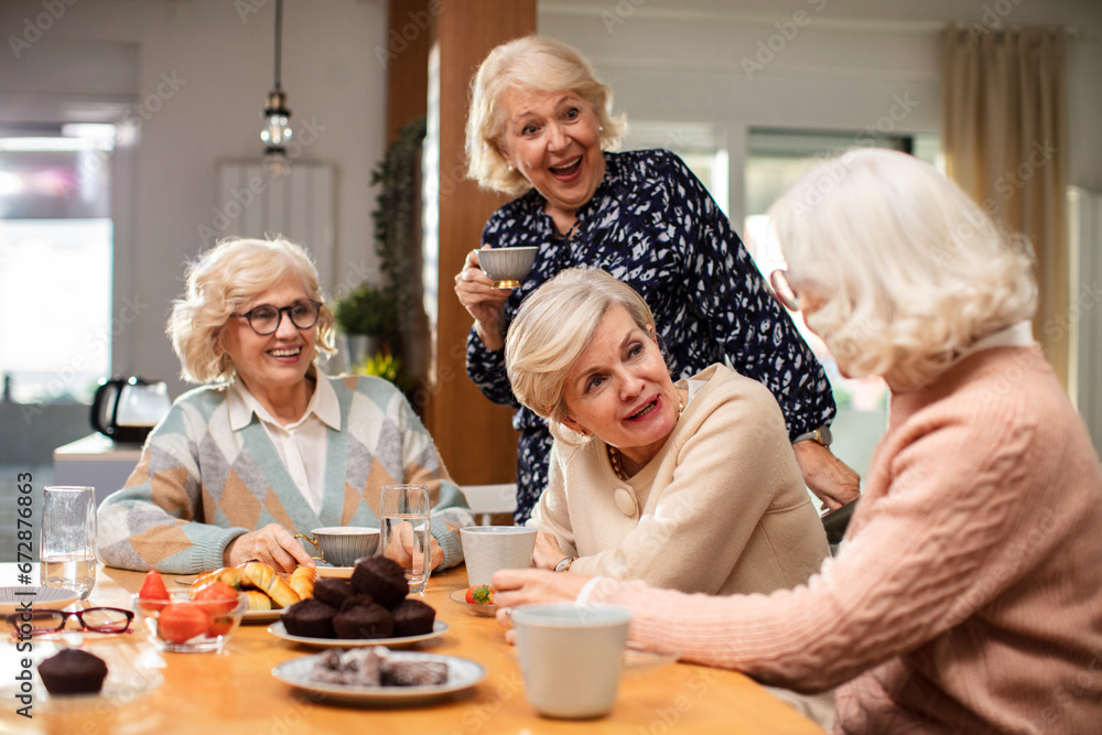 Senior women talking at the kitchen table Senior women talking at the kitchen table