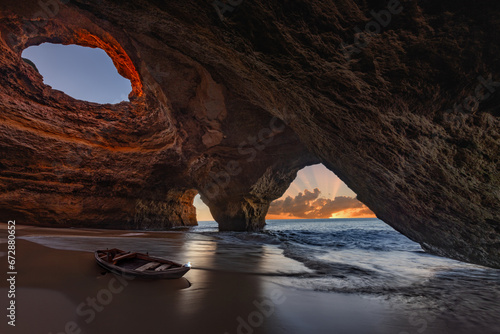 A spectacular view of the sunrise in the sea cave of Benagil in the Algarve, Portugal, Europe