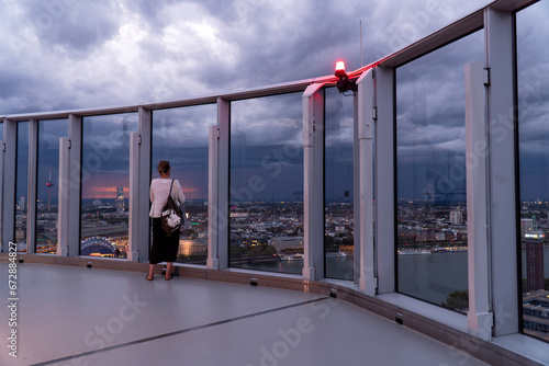 woman looks at the city of Cologne from the Cologne Triangle observation deck photo