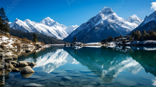 A photo of snow-capped peaks, with pristine alpine lakes as the background, during the winter season
