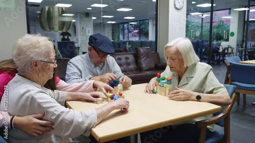 Old people and nurse playing skill brain games photo