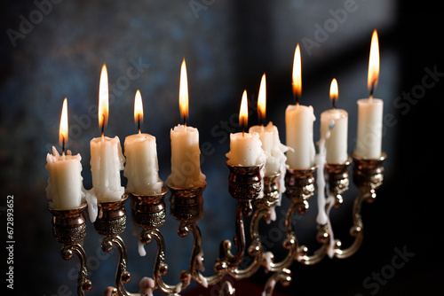 Jewish religious holiday Hanukkah with holiday Hanukkah (traditional candelabra) on a dark background photo