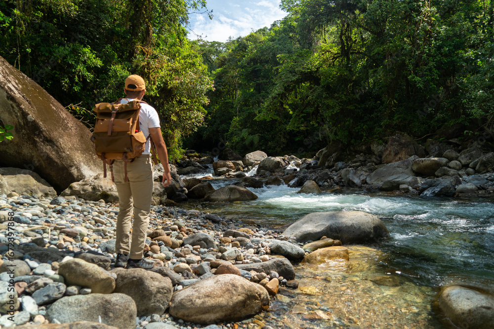Lonely man looking at the jungle and nature, panoramic photo of the Amazon. Lonely man looking at the jungle and nature, panoramic photo of the Amazon.