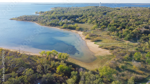 Aerial view a secondary point or hump surrounding by lush green trees and curved sandy shoreline at Isle du Bois Ray Roberts Lake State Park, remote primitive camping sites photo
