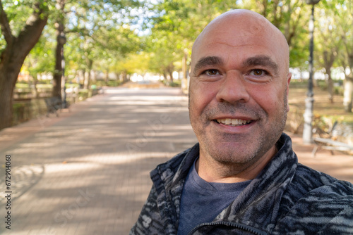 Happy man takes a selfie in the forest