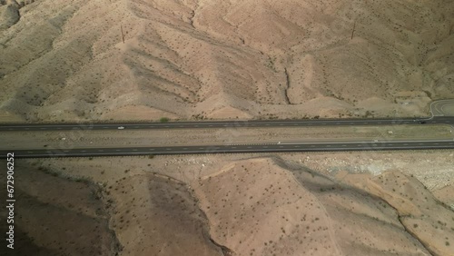 Aerial tilt down on divided highway in Arizona desert