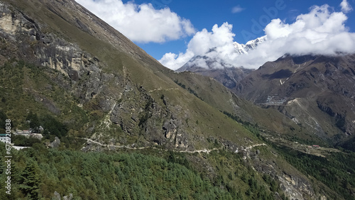 Mountain landscape of Nepal with snowy peaks with clouds in sunny weather