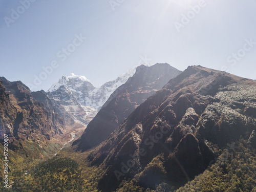 Mountain landscape of Nepal with snowy peaks with clouds in sunny weather