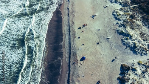 Aerial view of a populated beach with people resting on the beach