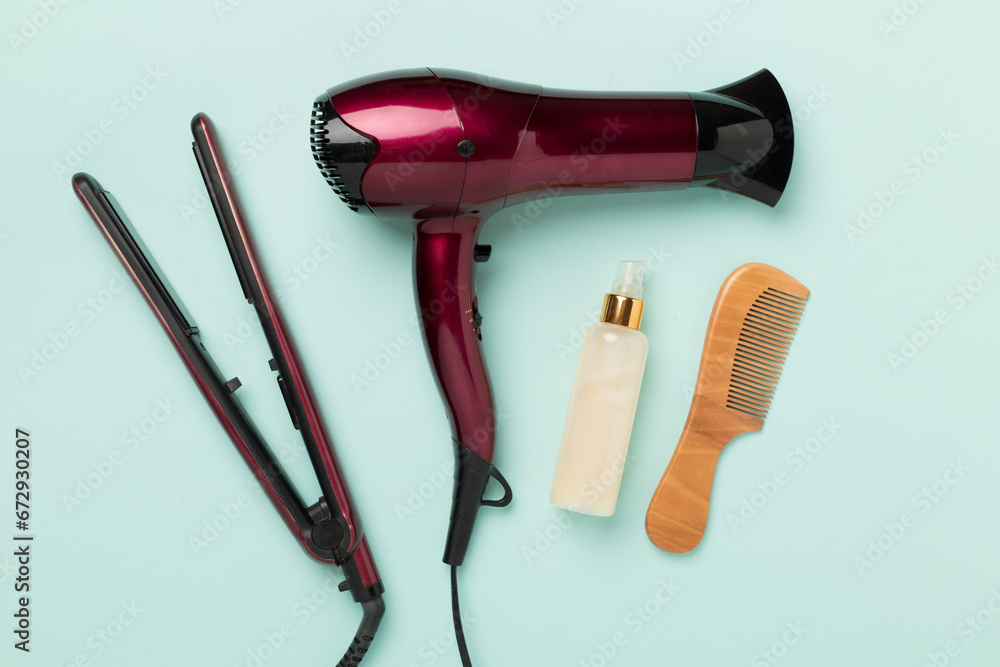 Hair tools with thermo protection on color background, top, view Hair tools with thermo protection on color background, top, view