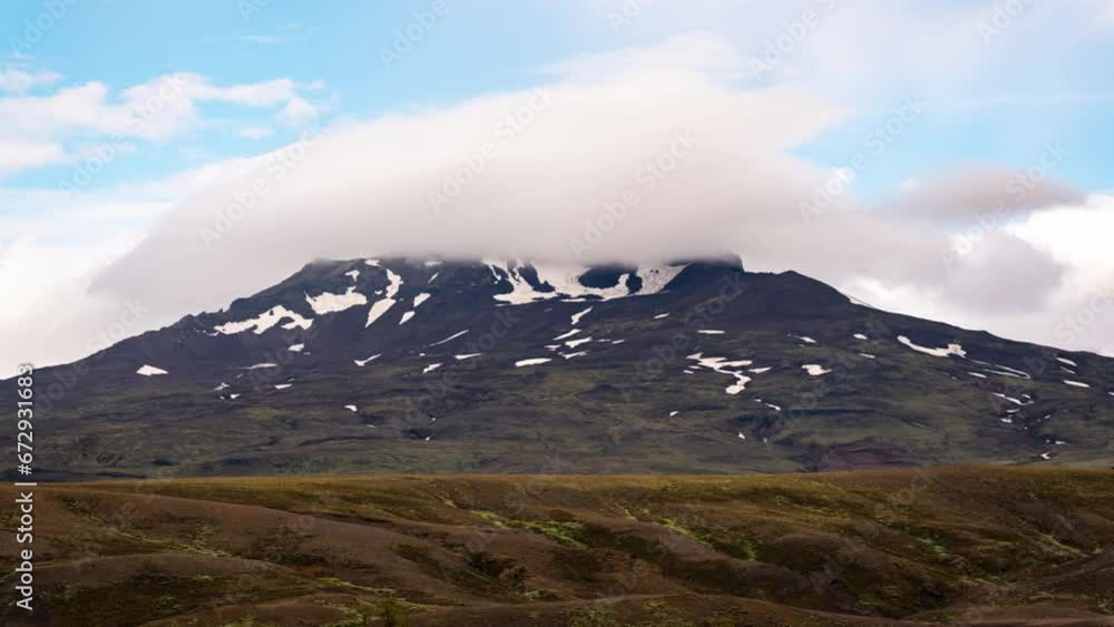 Natural cap cloud blowing over mountain in highlands of iceland on daylight at Thorsmork Natural cap cloud blowing over mountain in highlands of iceland on daylight at Thorsmork
