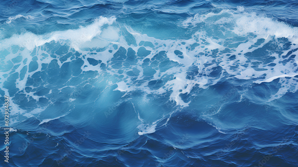 Blue and crystalline water. Waves in the ocean. View from above. Textured background.