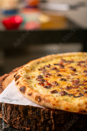 Pizza dough being prepared with cheese, tomato sauce, cheese