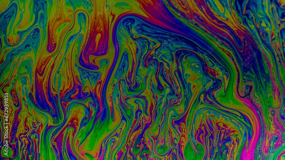 a liquid substance on the surface of water with blue and pink a liquid substance on the surface of water with blue and pink