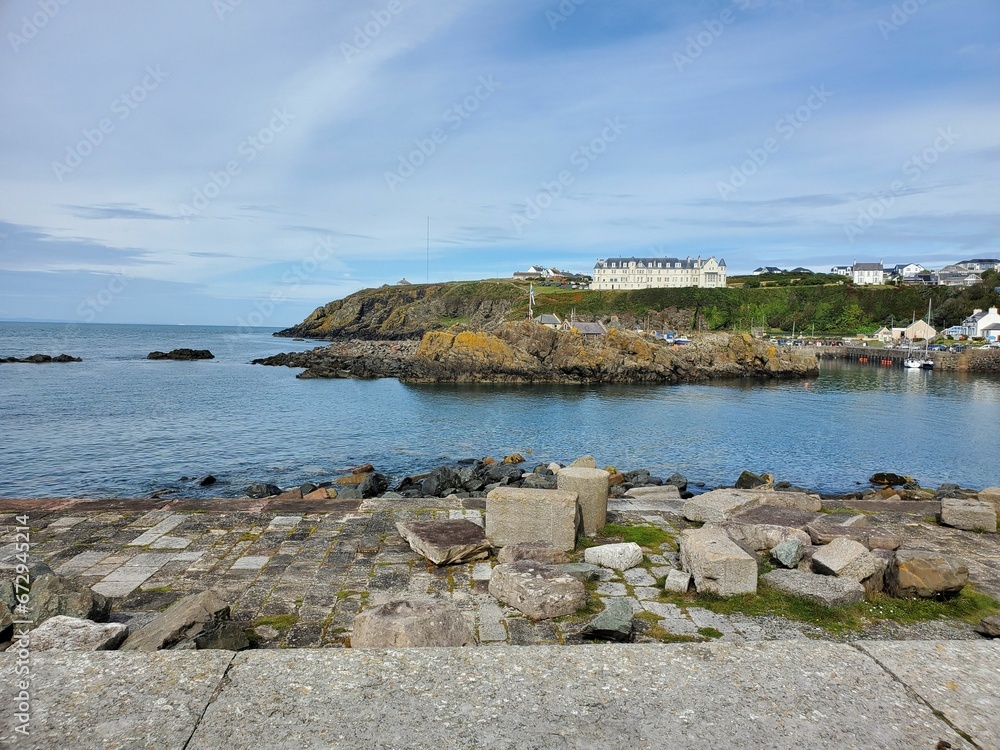Scenic pathway paved with stones leading to a picturesque building near the shoreline