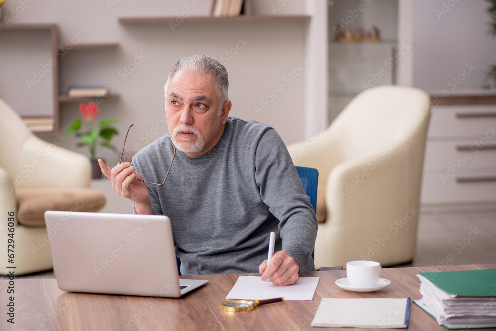 Old male employee working from home during pandemic Old male employee working from home during pandemic