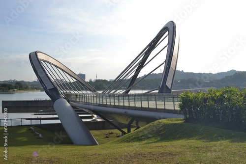 the pedestrian bridge is crossing over a river in the daytime