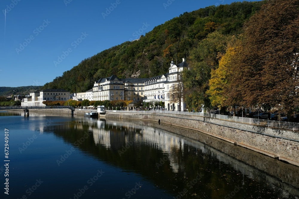Tranquil lake with buildings and green hills on the shore. Bad Ems, Rhineland-Palatinate, Germany.