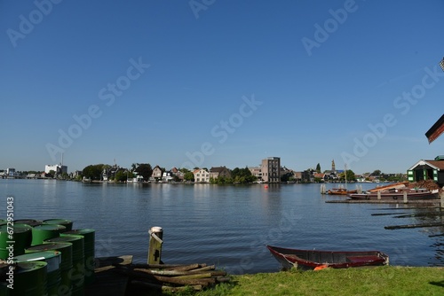 Fototapeta Naklejka Na Ścianę i Meble -  Scenic view of a small harbor on the banks of a river with several boats docked in the foreground