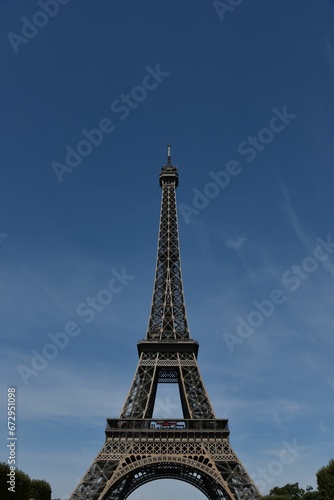 Iconic Eiffel Tower in Paris on the backdrop of the sky © Wirestock