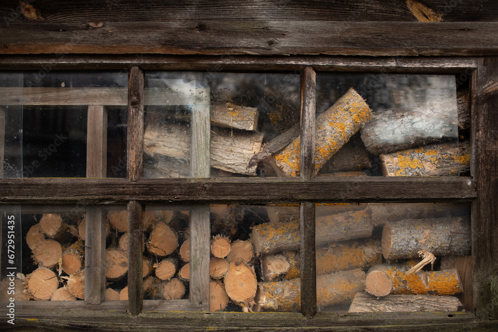 A stack of firewood in an old shed, supplies for the winter to heat the house. A stack of firewood in an old shed, supplies for the winter to heat the house.
