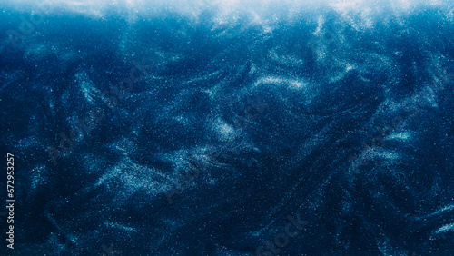 Dust particles background. Glitter swirls. Light shimmering shiny liquid sparks ink flow on dark blue abstract hypnotic mysterious space art.