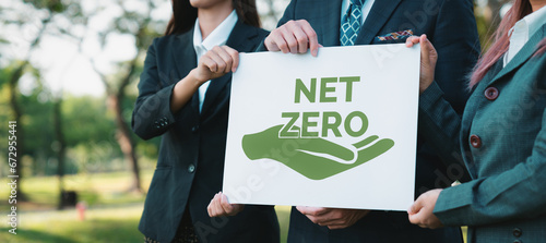 Group of business people stand united, holding eco-friendly idea and concept for environmental awareness campaign by business corporate to embrace net zero emission and environmental friendly. Gyre