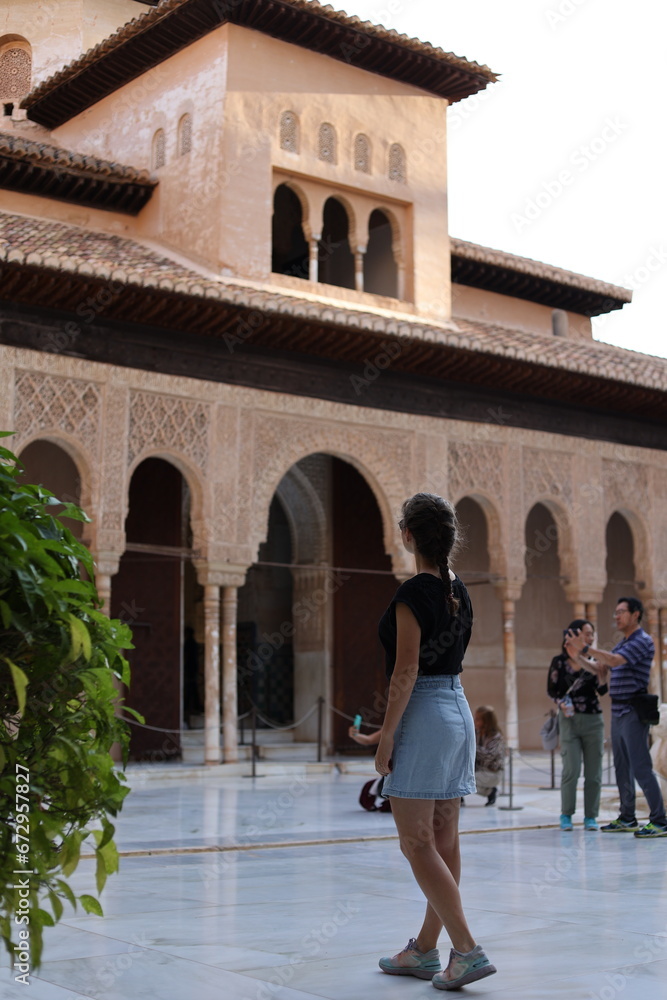 woman walking in the Alhambra of Granada, Andalusia, Spain