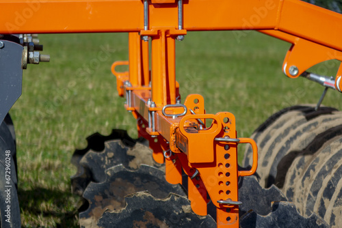 detail of plow farming equipment machine cultivator on a field working photo