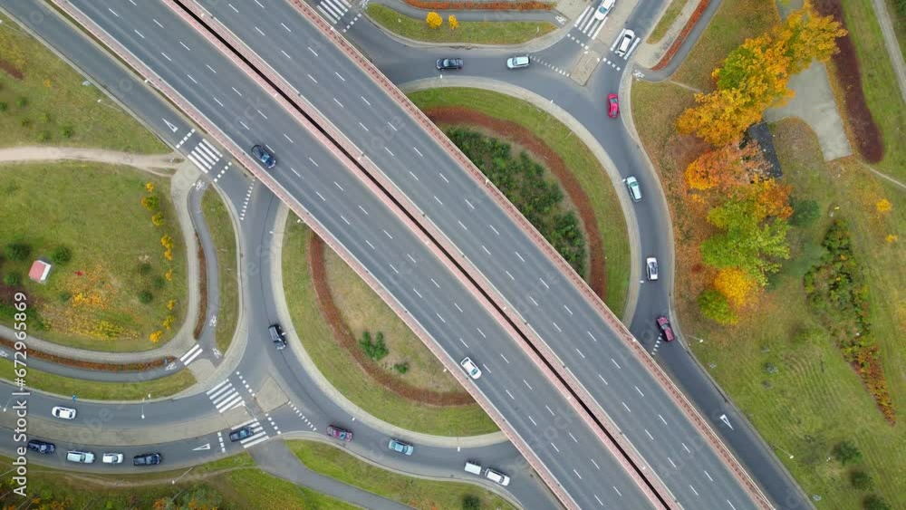 traffic on a highway and rondabout, drone top-down footage, beautiful day traffic on a highway and rondabout, drone top-down footage, beautiful day