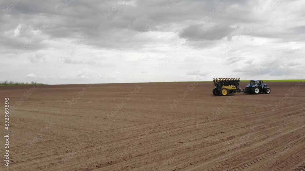 Tractor On The Field Planting Sunflower in Ukraine Tractor On The Field Planting Sunflower in Ukraine