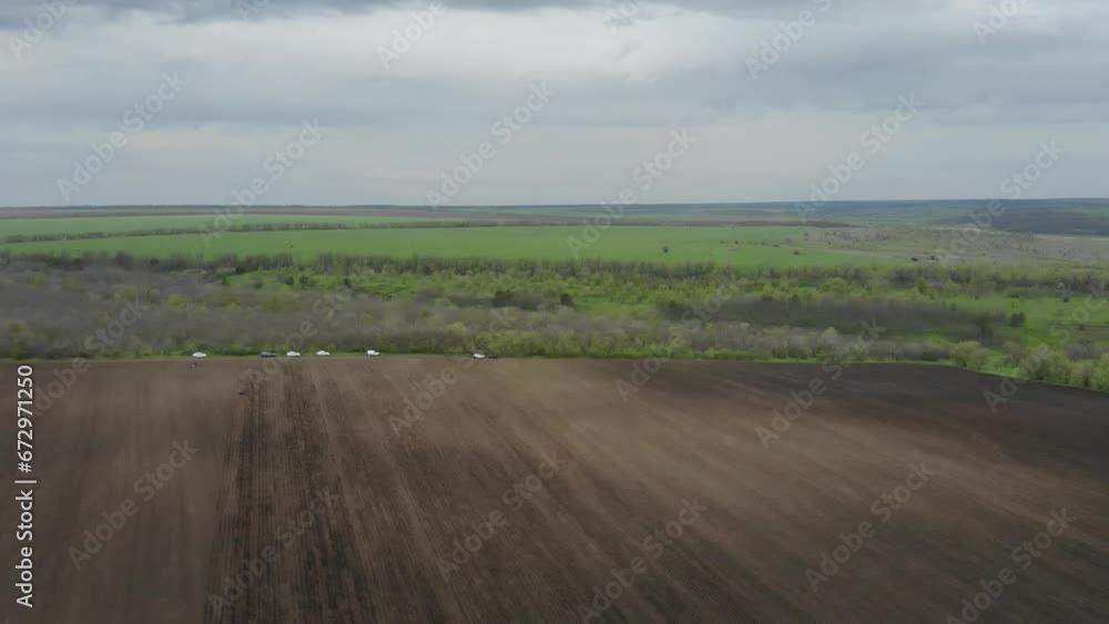 Tractor On The Field Planting Sunflower in Ukraine Tractor On The Field Planting Sunflower in Ukraine